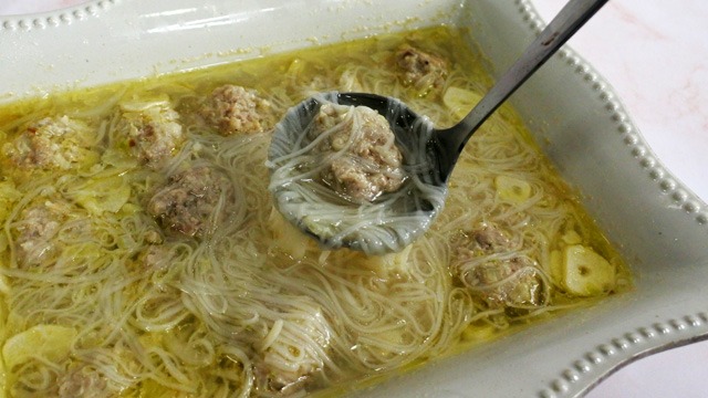 Almondigas soup in a square bowl