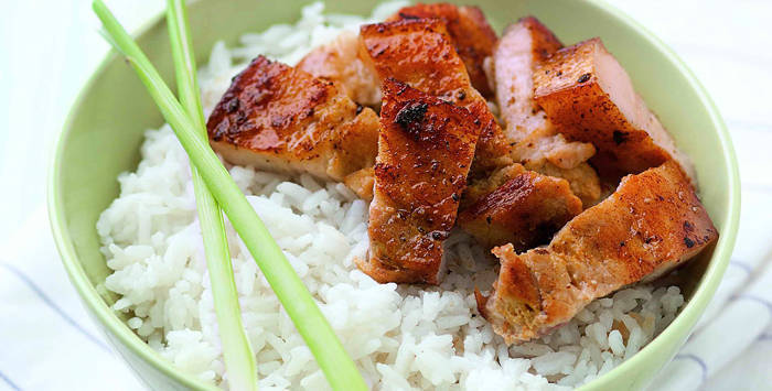 coconut liempo rice topped with liempo and lemongrass