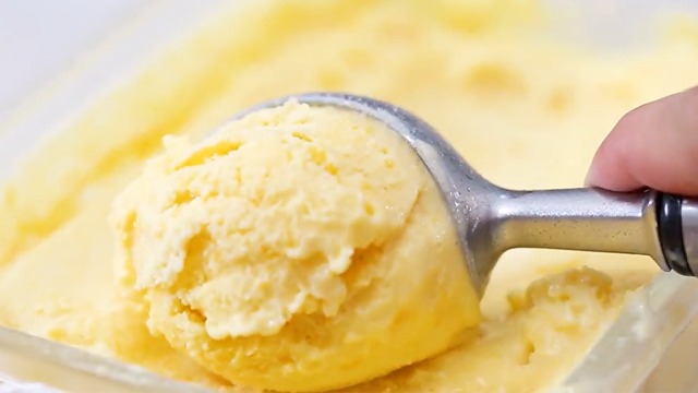 mango ice cream being scooped