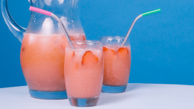 starbucks pink drink in clear glasses with a pitcher in the background